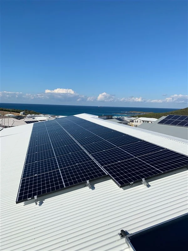 Solar array on a Colorbond roof looking out to the ocean